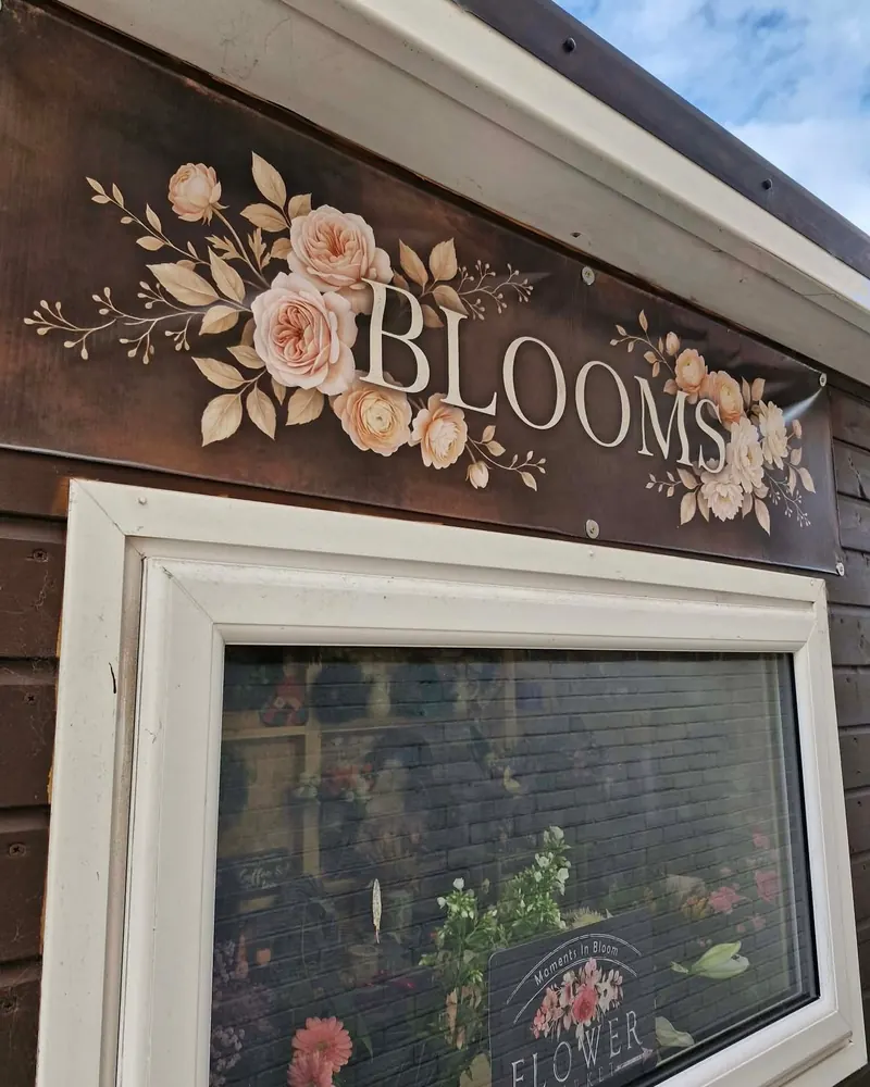 Floral ACM fascia sign for Blooms florist above a shop window