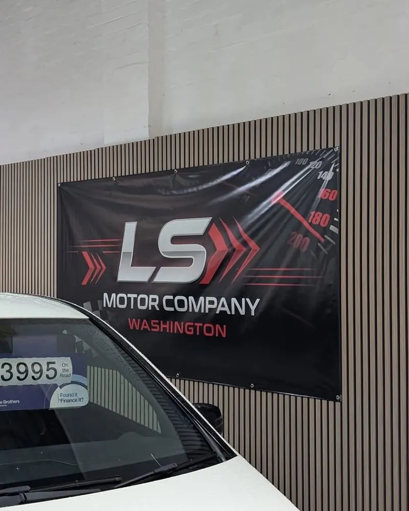 PVC banner for LS Motor Company in Washington, fixed to a slatted wall
