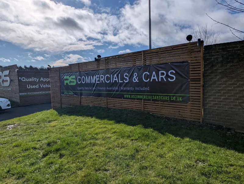 Long PVC banner for RS Commercials & Cars fixed along a timber fence