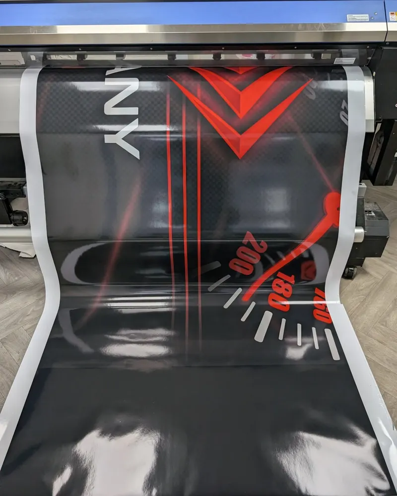 A sign print for LS Motor Company coming off the Roland printer at our Washington factory